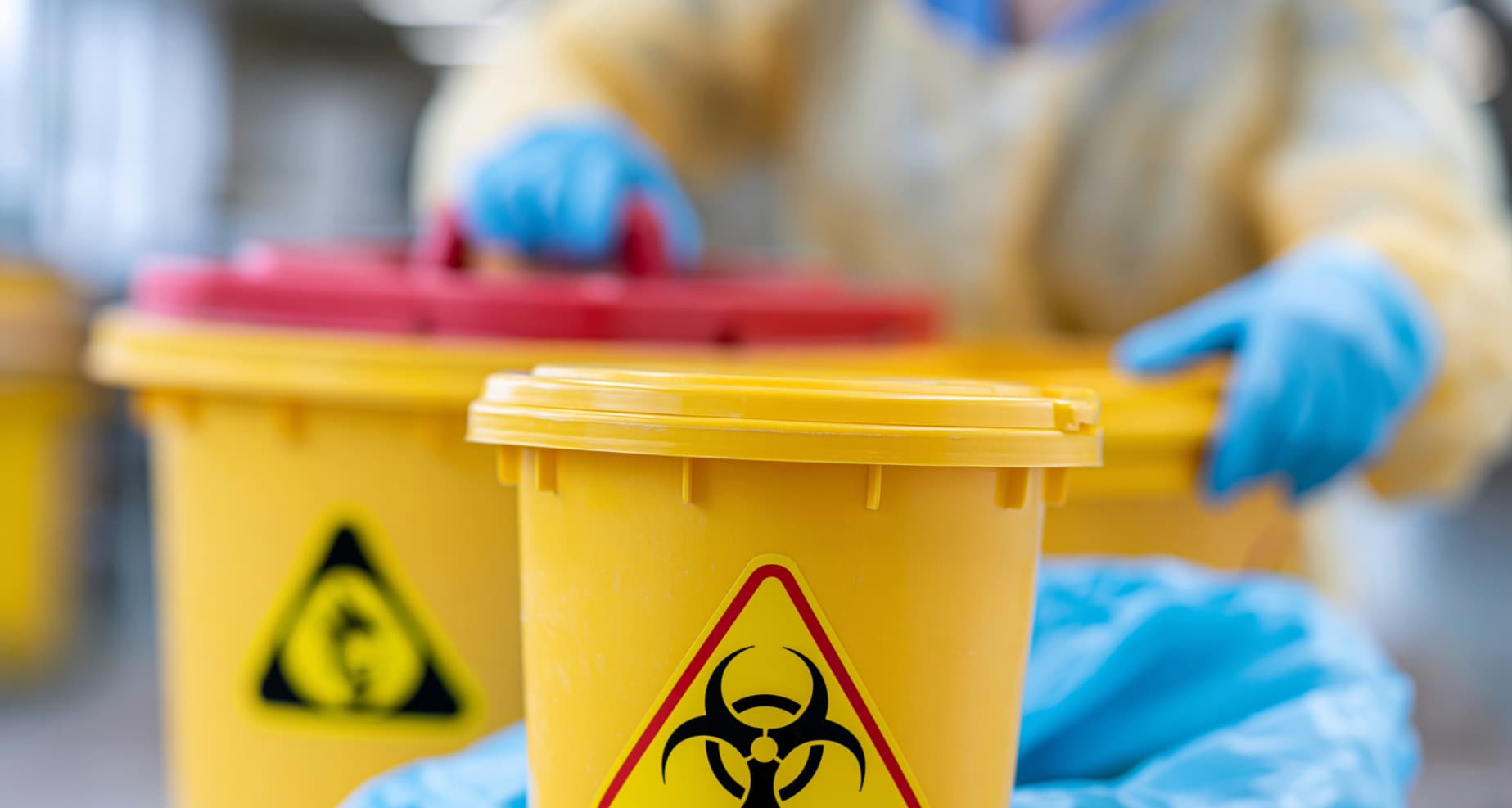 Employee wearing protective equipment while handling hazardous chemical