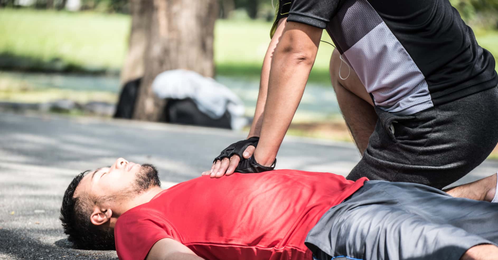 CPR training using adult child and baby manikins in a first aid class