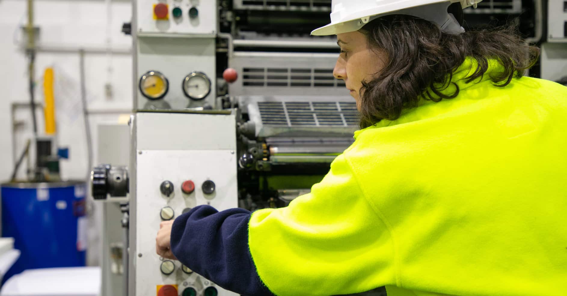 Engineer safely operating workshop machinery while wearing appropriate personal protective equipment.
