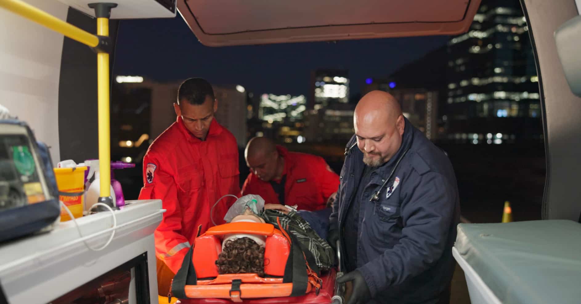 First aider speaking to ambulance crew during emergency handover