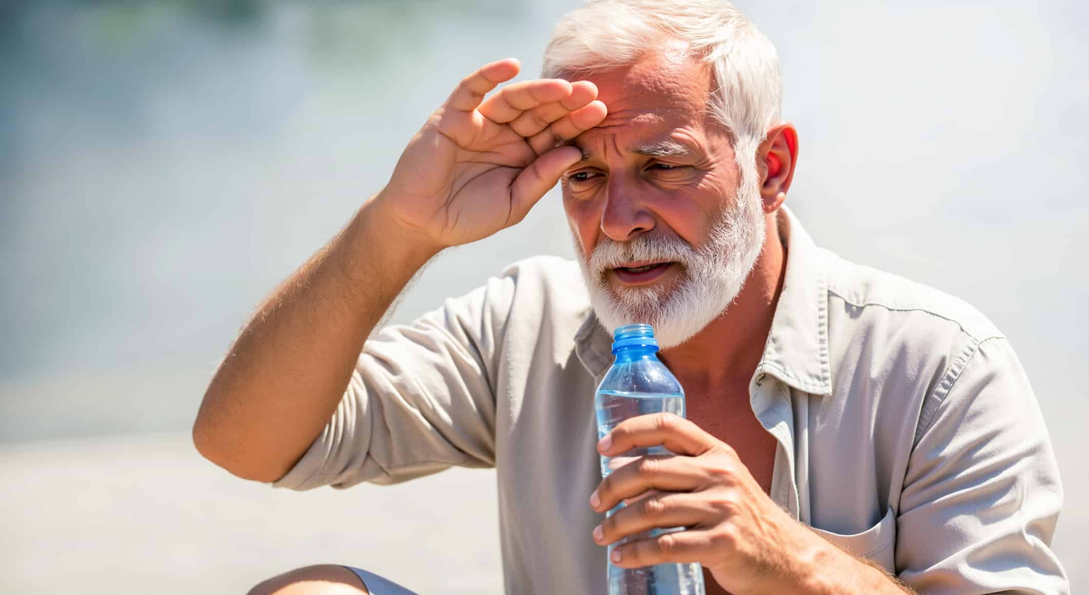 Person cooling down with water as first aid for heat exhaustion.