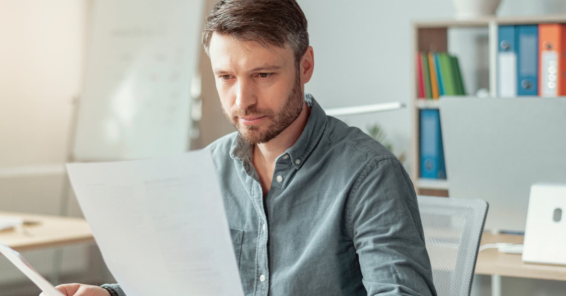 Workplace manager investigating an accident and reviewing safety records after an incident.