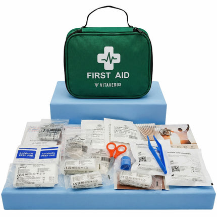 First aid kit with various supplies on a blue platform, branded as Vitaverus.