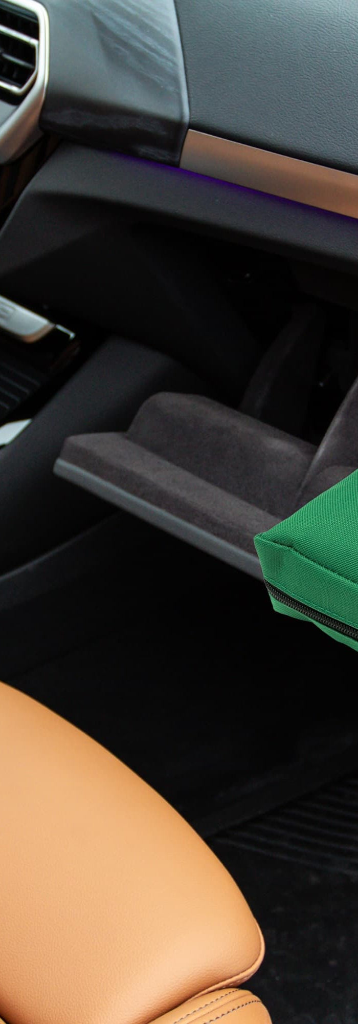 Green first aid kit in a car's console