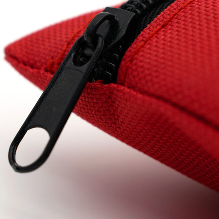 Close-up of a red fabric pouch with a black zipper on a white background