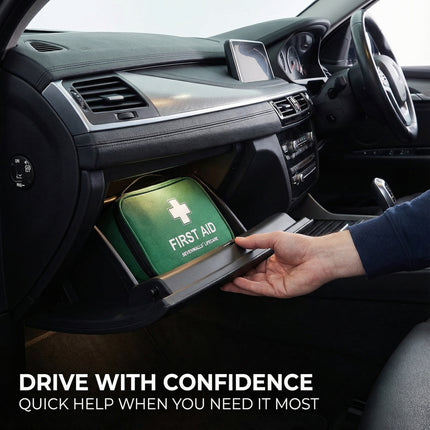 Hand placing a first aid kit into a car's console with 'Drive with Confidence' text.