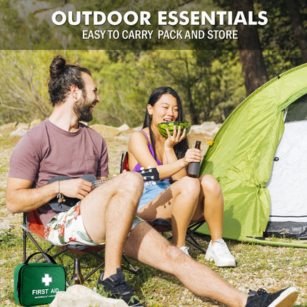 Two people sitting outdoors with a green tent and first aid kit, enjoying a picnic.