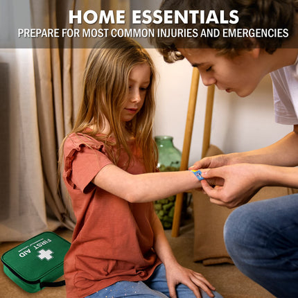 Person applying bandage to a child's arm with a first aid kit in the foreground.