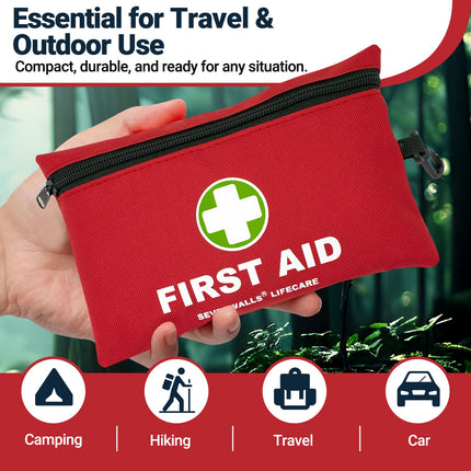 Red first aid kit held by a hand with outdoor background