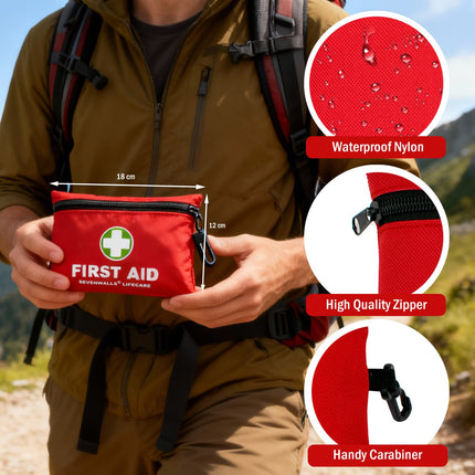 Person holding a red first aid kit with mountainous background