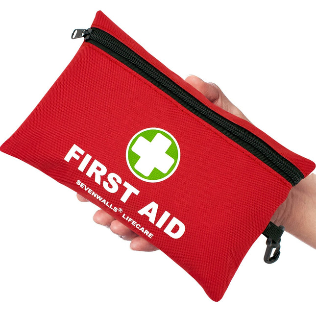Red first aid kit with 'Sevenwalls Lifecare' branding held by a hand on a white background