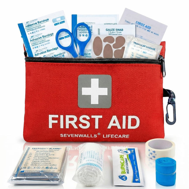 Red first aid kit with contents displayed on a white background