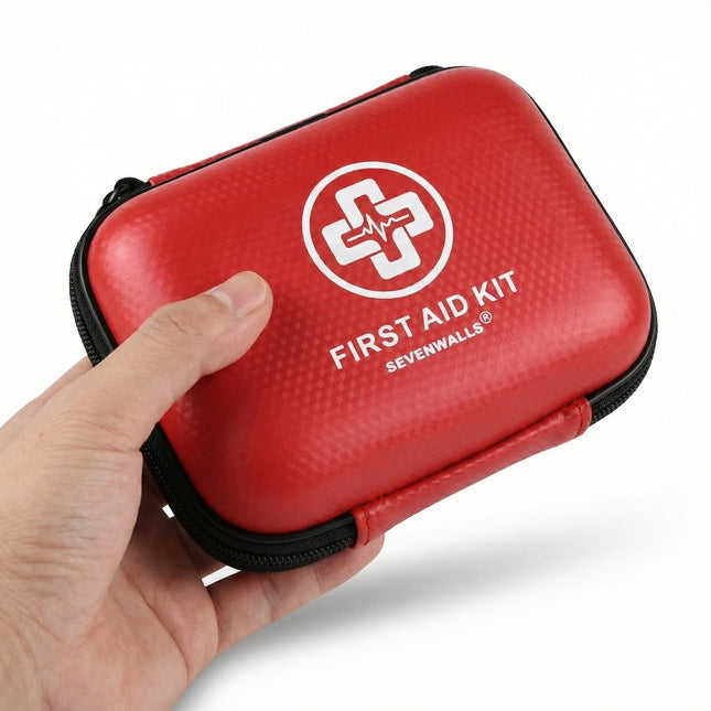 Red first aid kit with 'Sevenwalls' logo held by a hand on a white background
