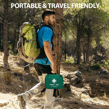 Man hiking with a green first aid kit and backpack in a forest setting