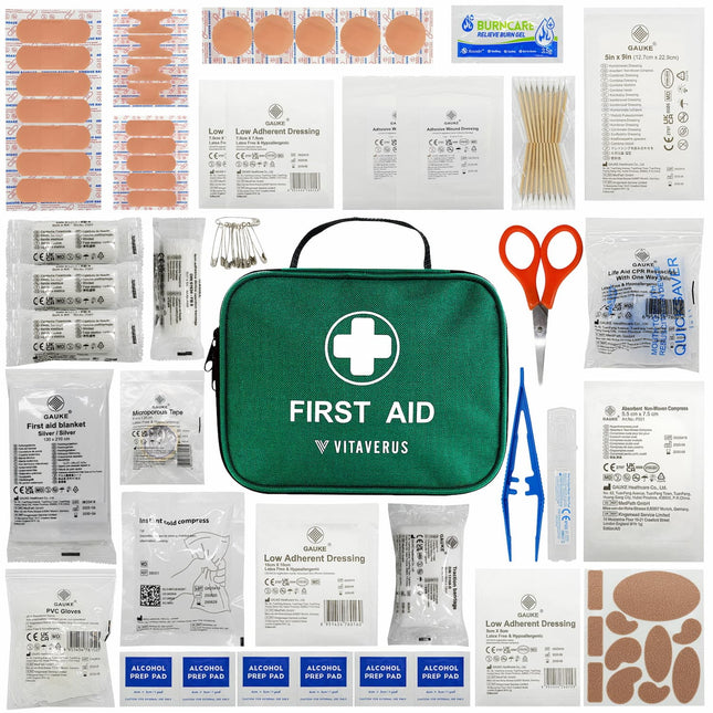 First aid kit with various supplies including bandages and scissors on a white background