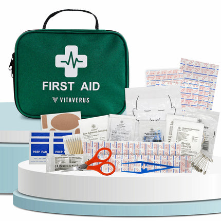 First aid kit with various supplies on a white background